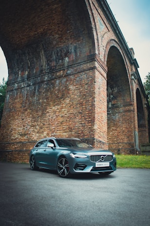 silver bmw m 3 coupe parked beside brick wall