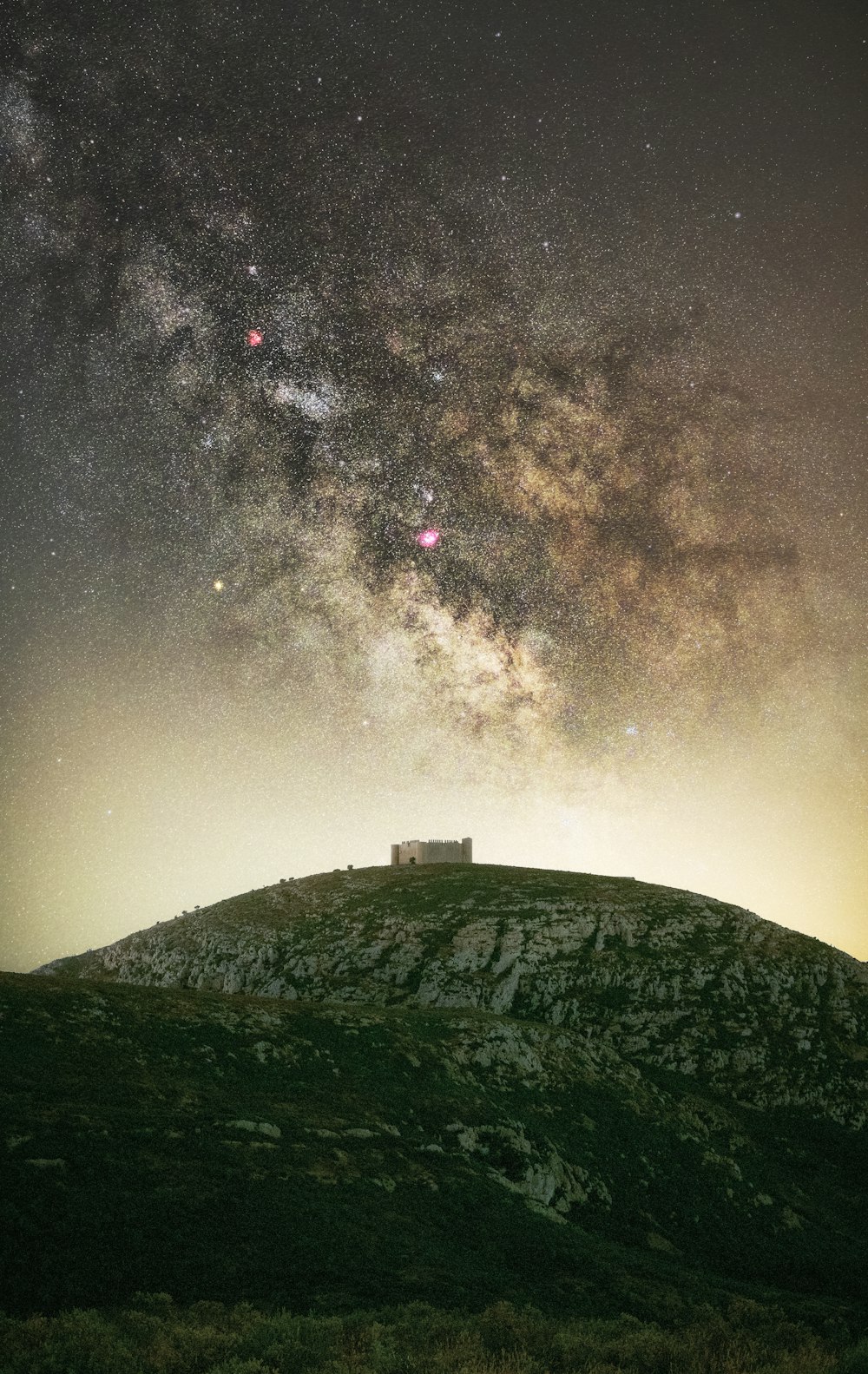 white house on green grass under starry night