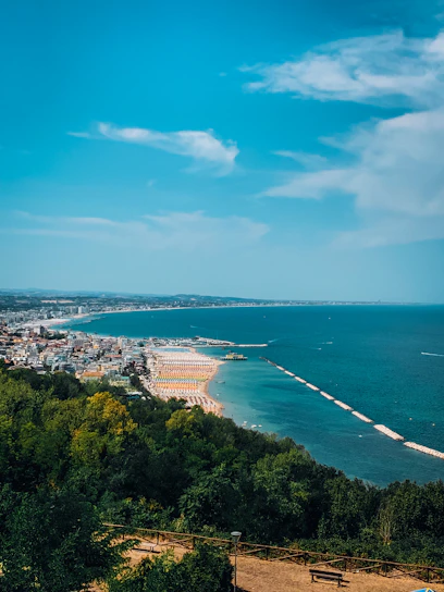 A panoramic view of Gran Canaria's coastline with turquoise waters and golden sandy beaches under a bright blue sky.