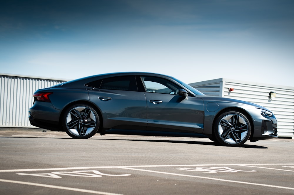 blue coupe on gray asphalt road during daytime