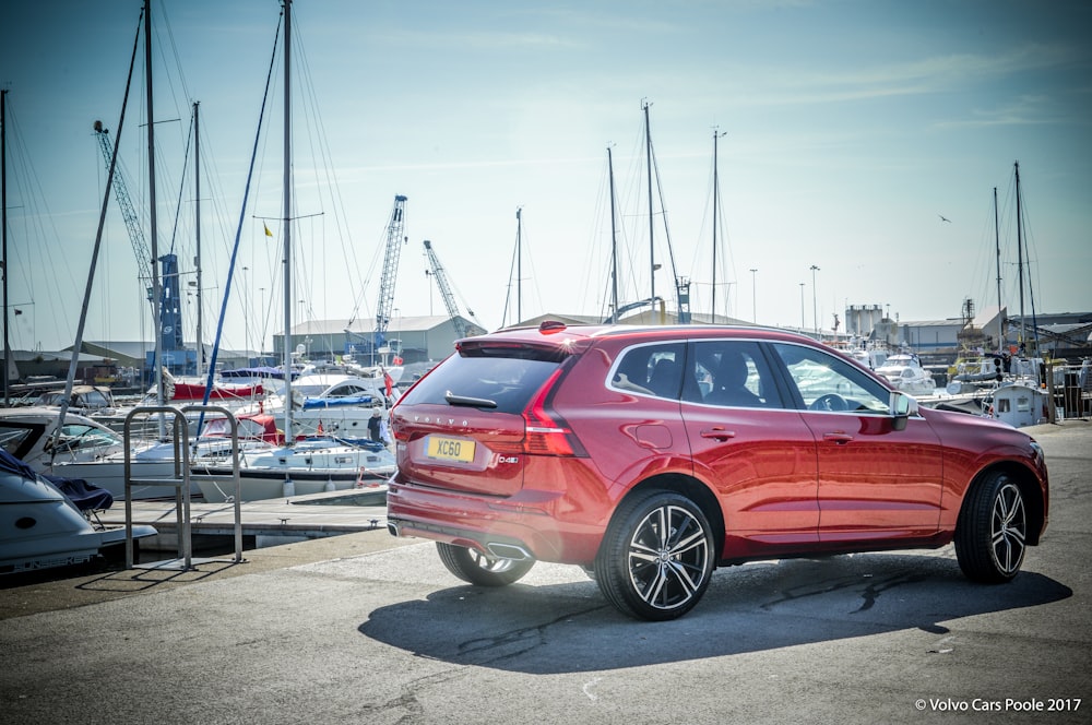 red bmw x 6 parked on parking lot during daytime