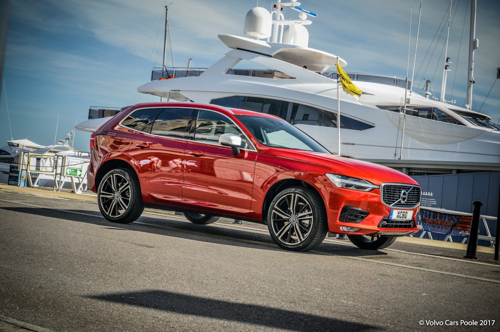 red bmw x 6 parked on parking lot during daytime