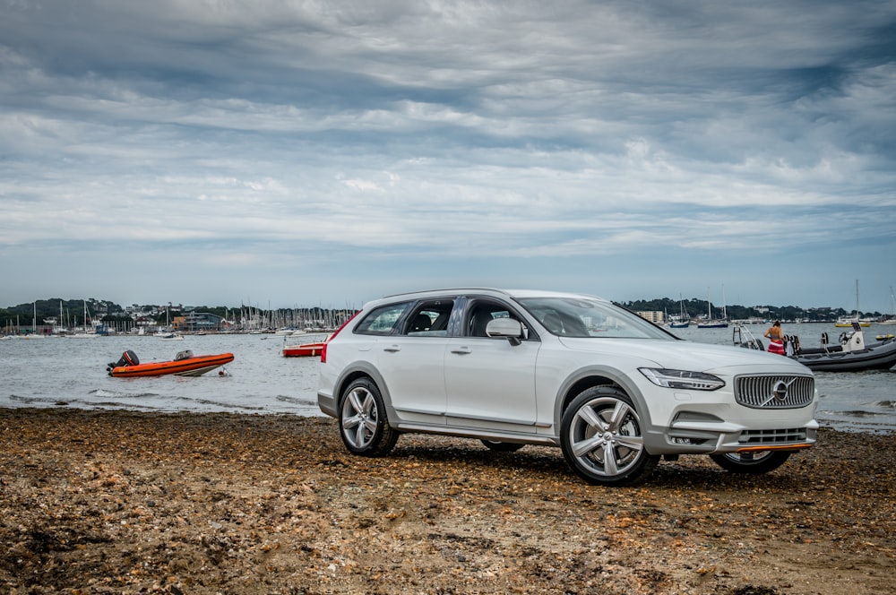 silver 5 door hatchback on brown sand during daytime