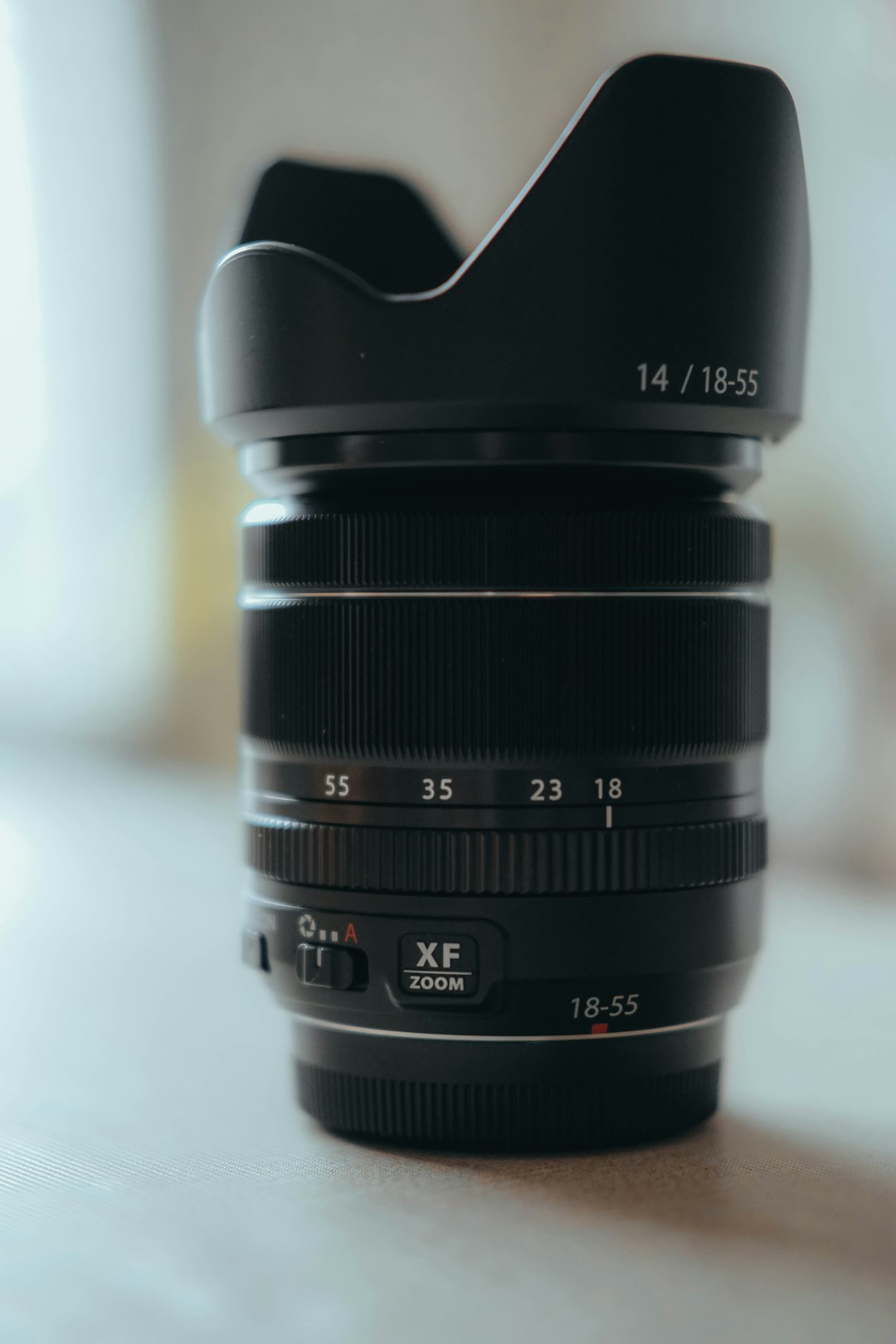 black camera lens on white table