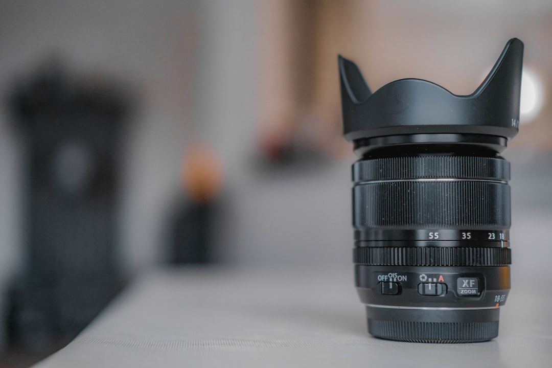 black camera lens on white table