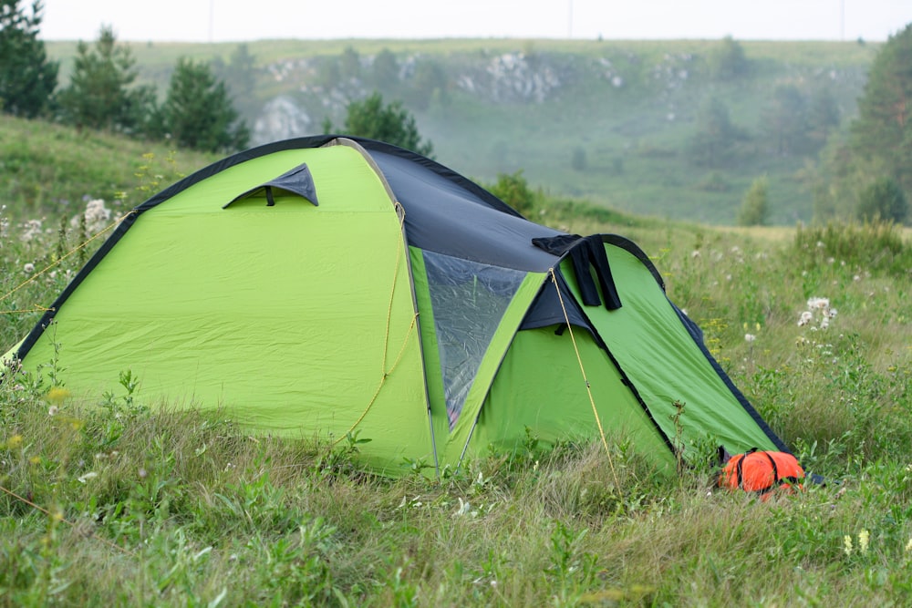 green dome tent on green grass field during daytime