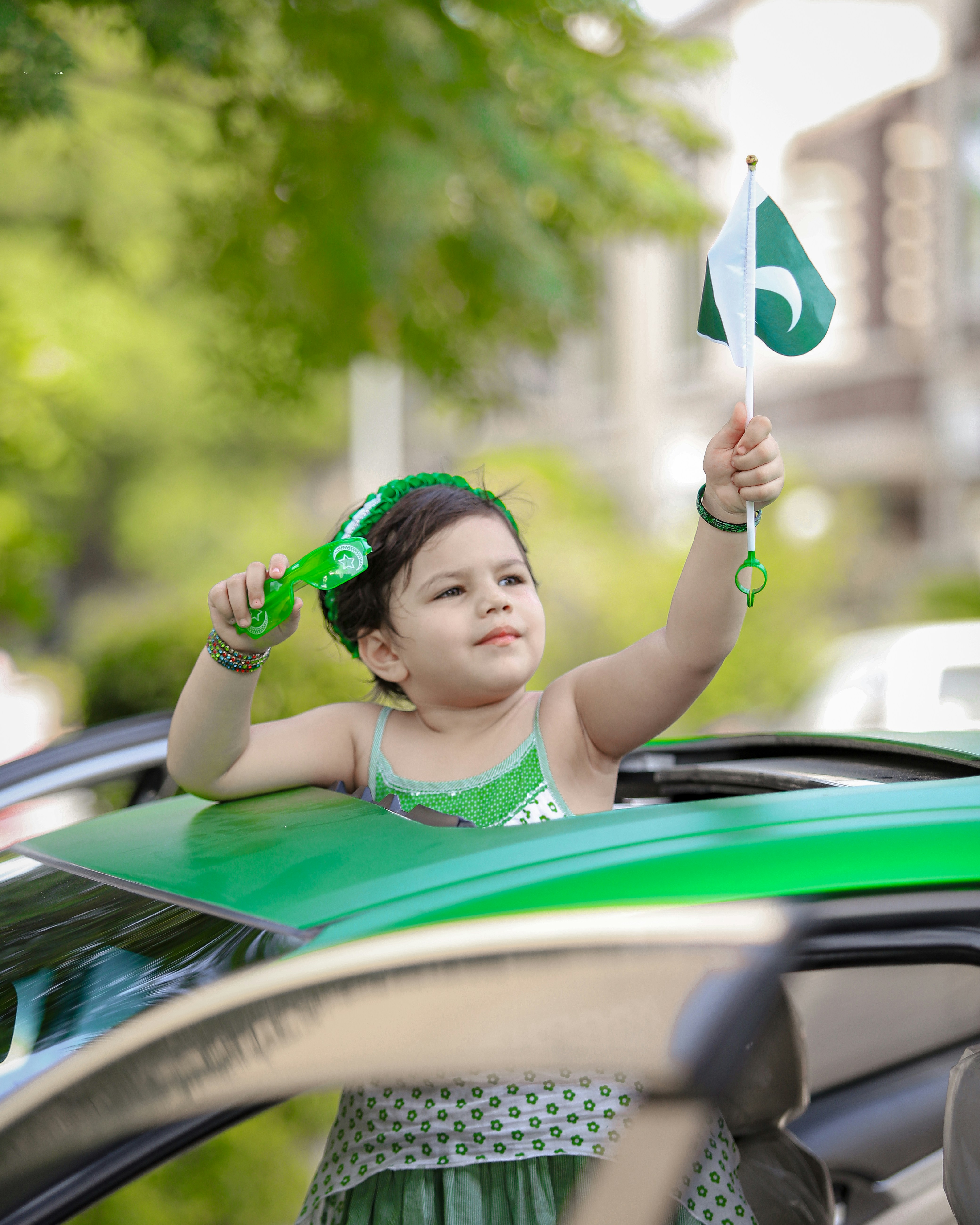 Woman in green tank top holding a white and blue umbrella photo Free