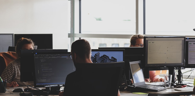 people sitting on chair in front of computer monitor