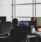 people sitting on chair in front of computer monitor