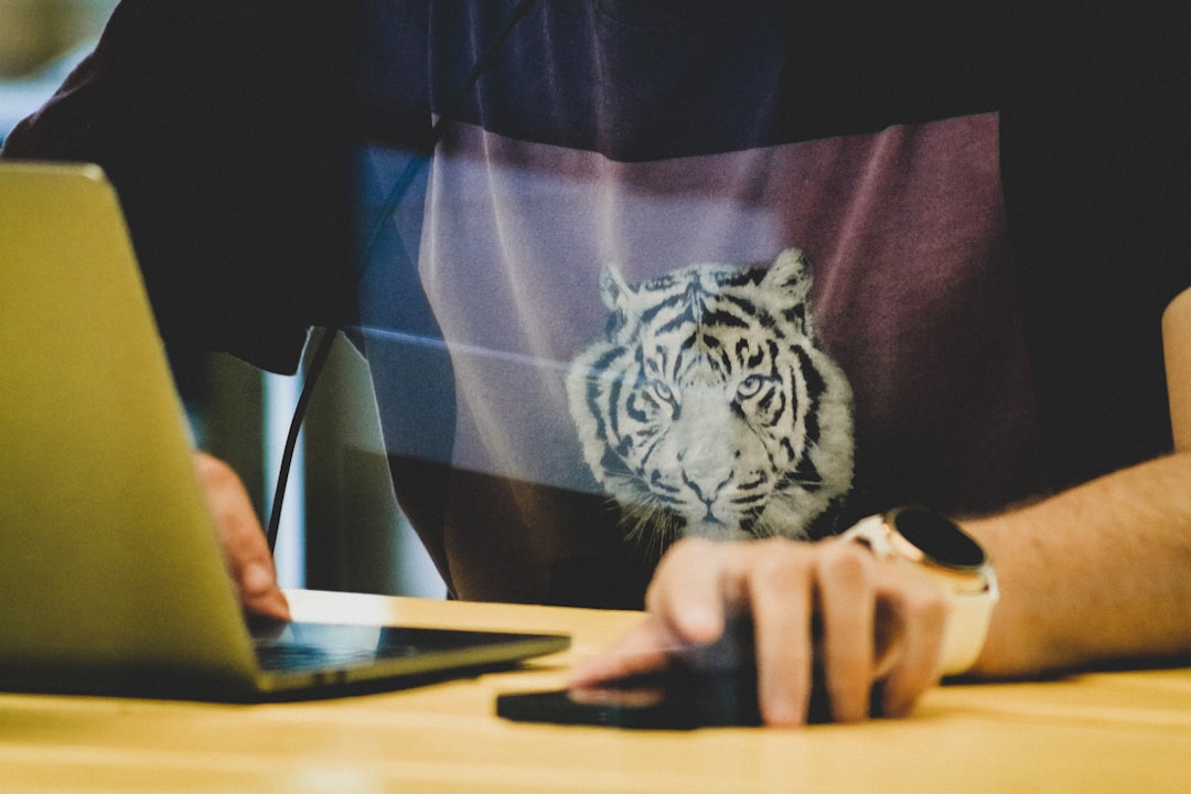 person holding white and black tiger printed textile