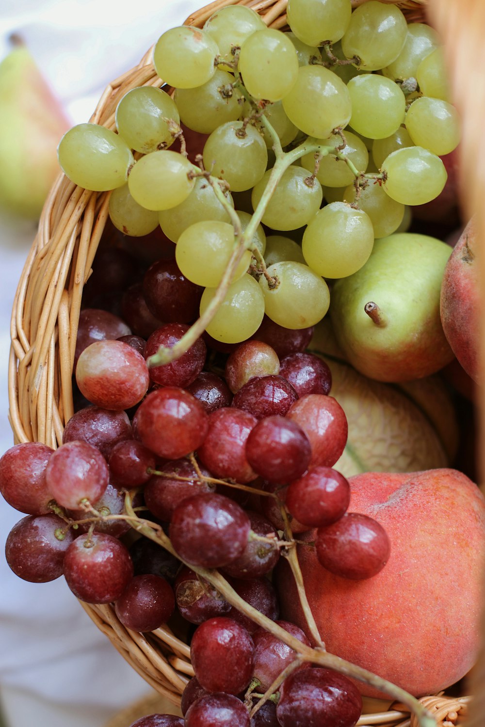 green and red apples on brown woven basket