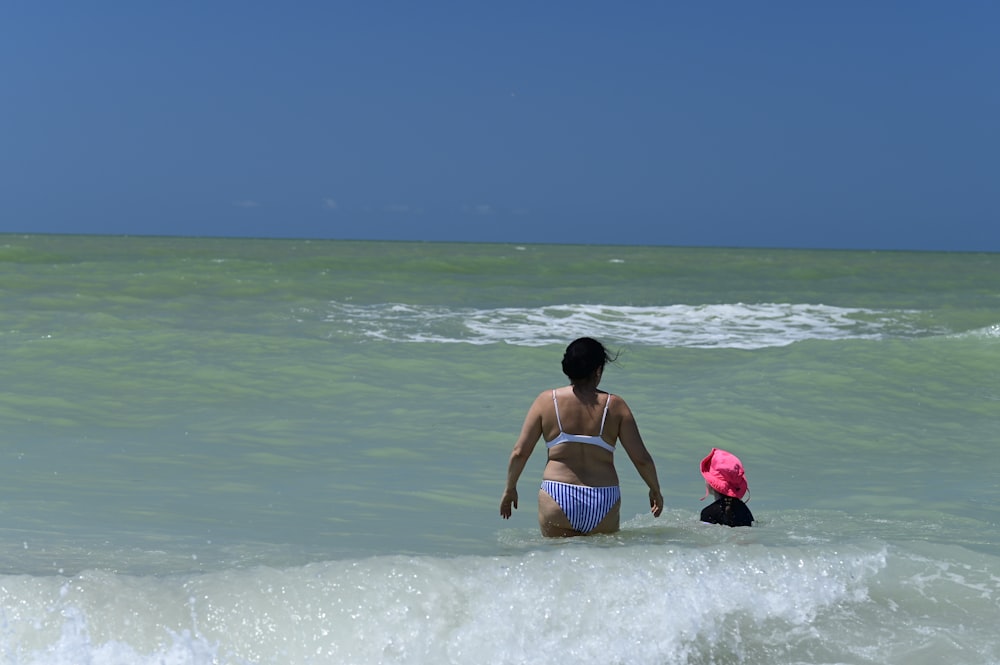 woman in black and white stripe bikini top on water during daytime