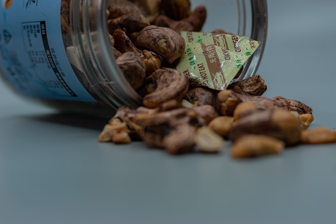 brown almond nuts on clear glass jar