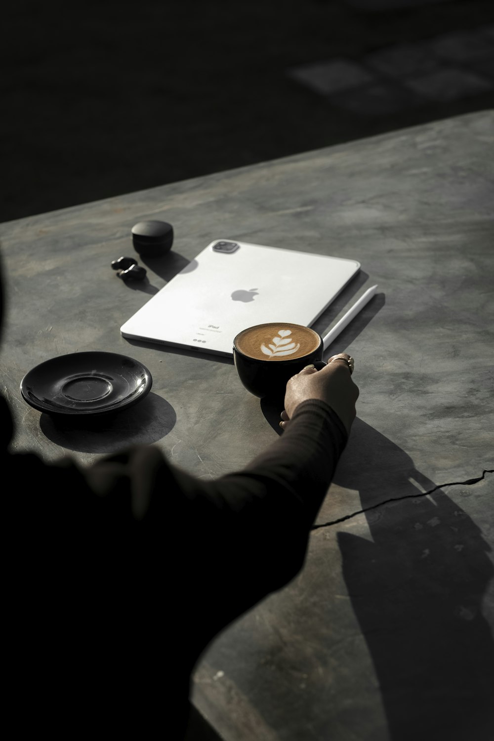 person holding white and black ceramic mug