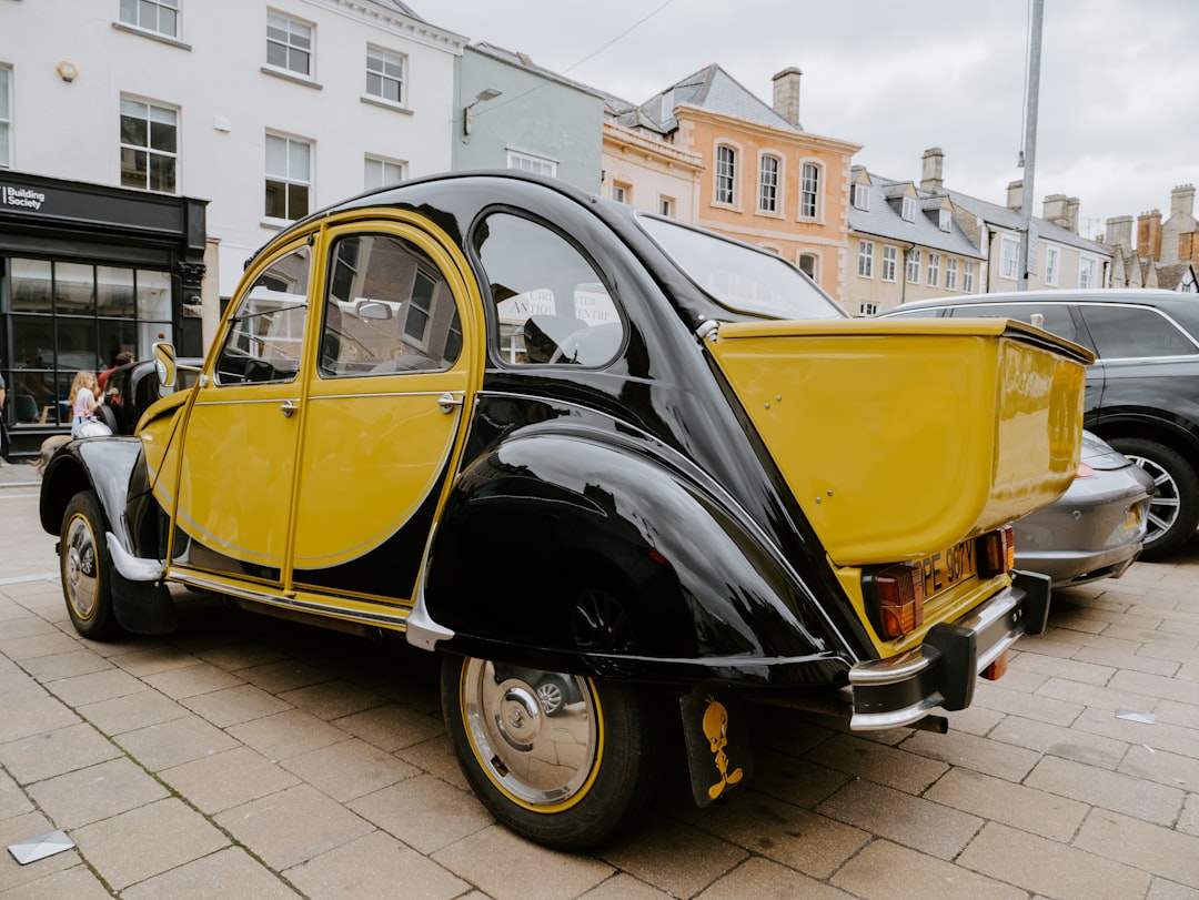 black and yellow vintage car on road during daytime