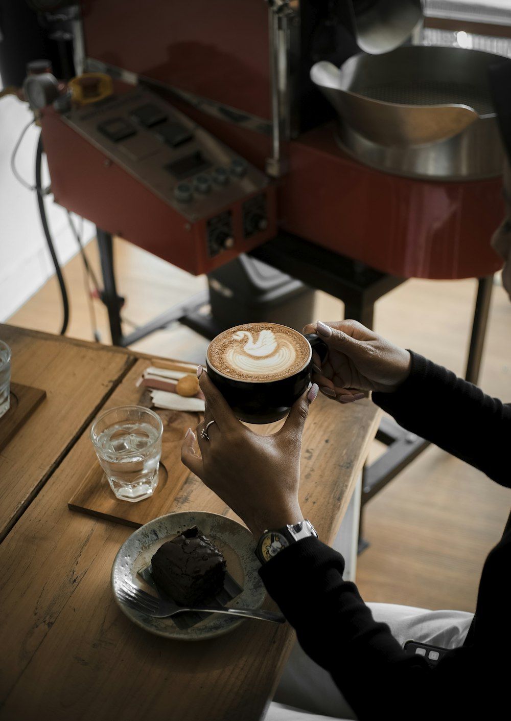 person pouring coffee on white ceramic mug