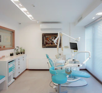 A bright, inviting dental office reception area decorated with peppermint and green accents, featuring smiling staff ready to help.