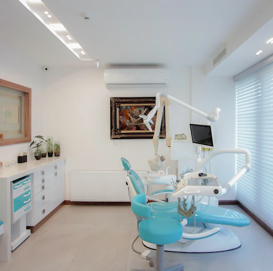 A bright, inviting dental office reception area decorated with peppermint and green accents, featuring smiling staff ready to help.