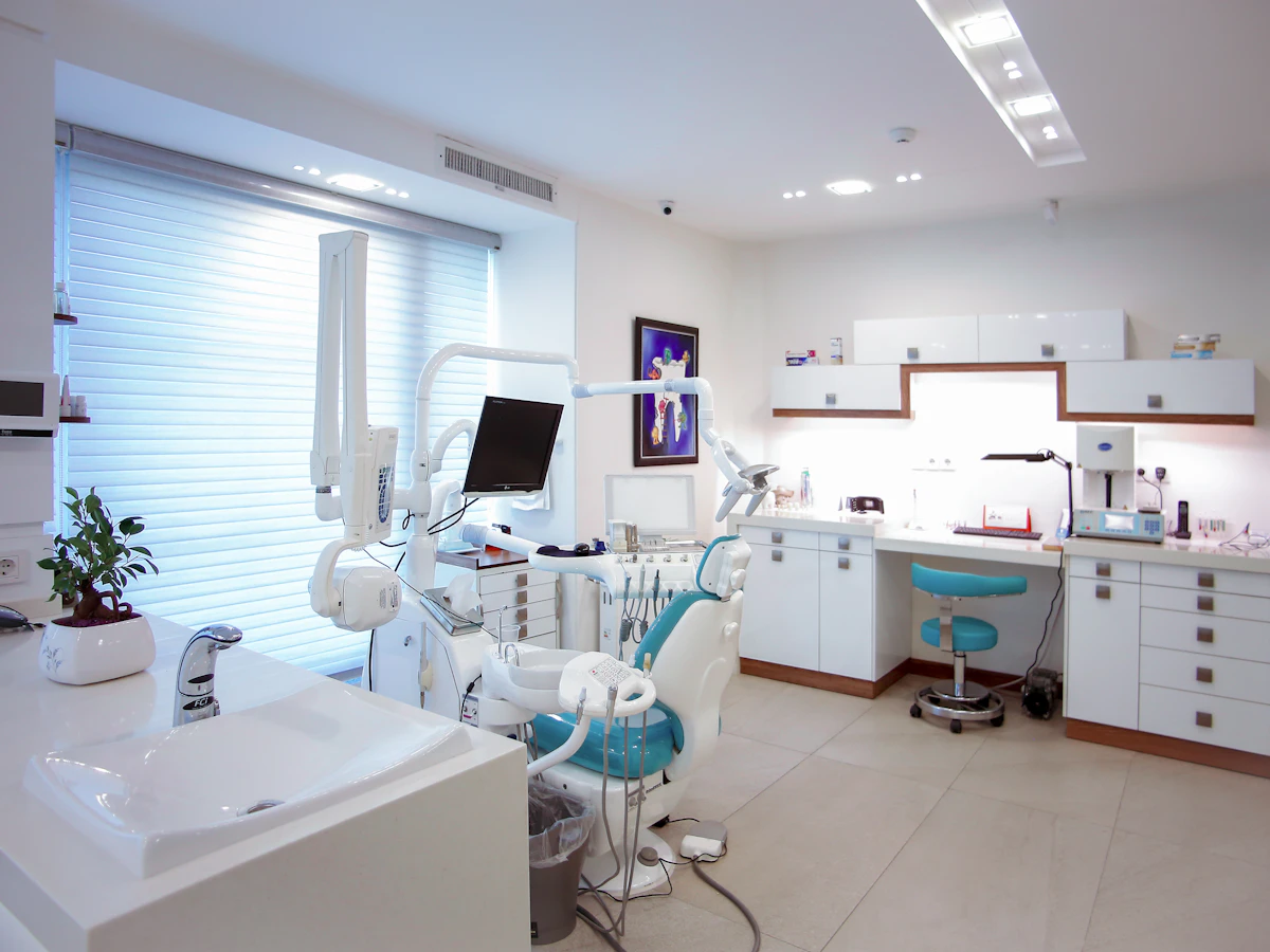 Modern dental surgery with a treatment chair and overhead equipment