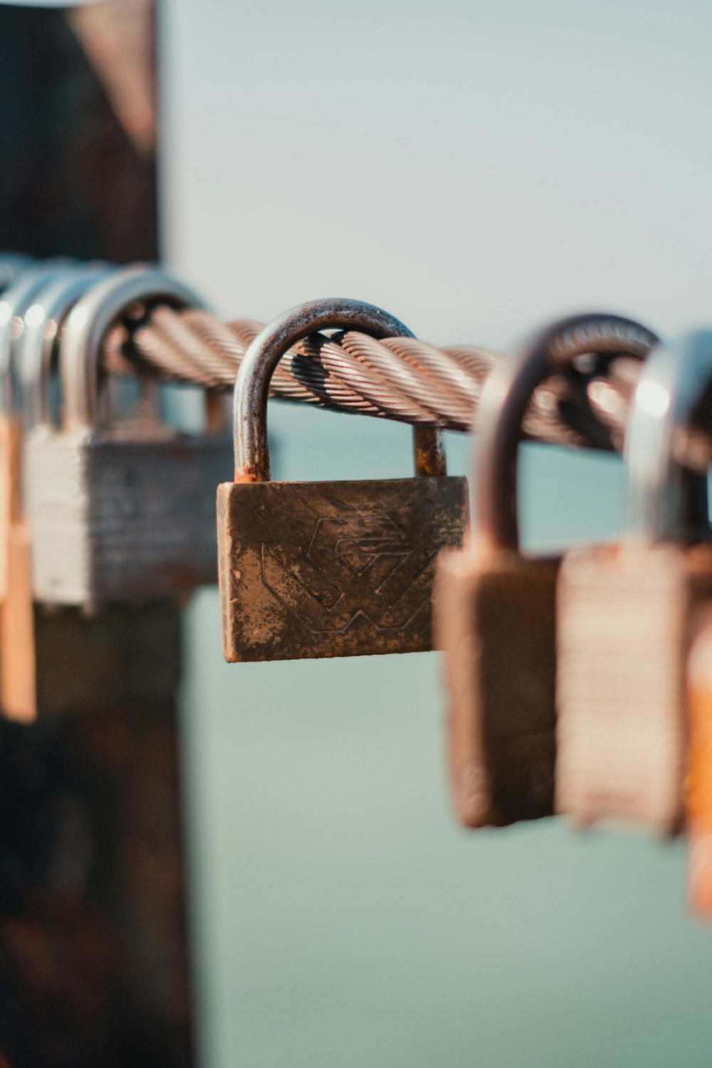 brown padlock on brown wooden fence