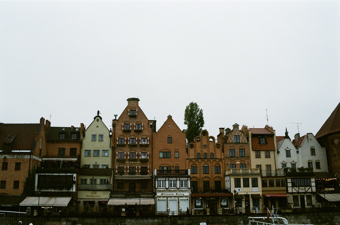 brown and white concrete building near body of water during daytime