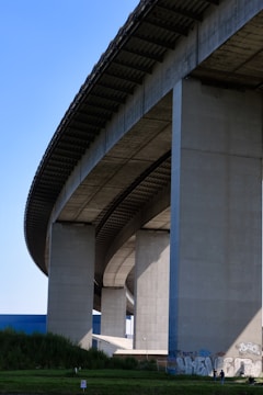 gray concrete bridge under blue sky during daytime