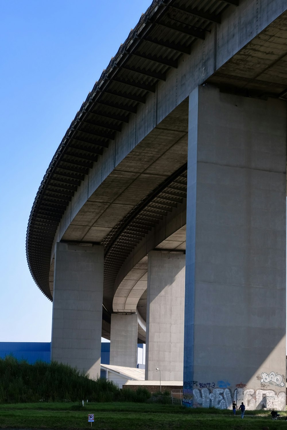 gray concrete bridge under blue sky during daytime