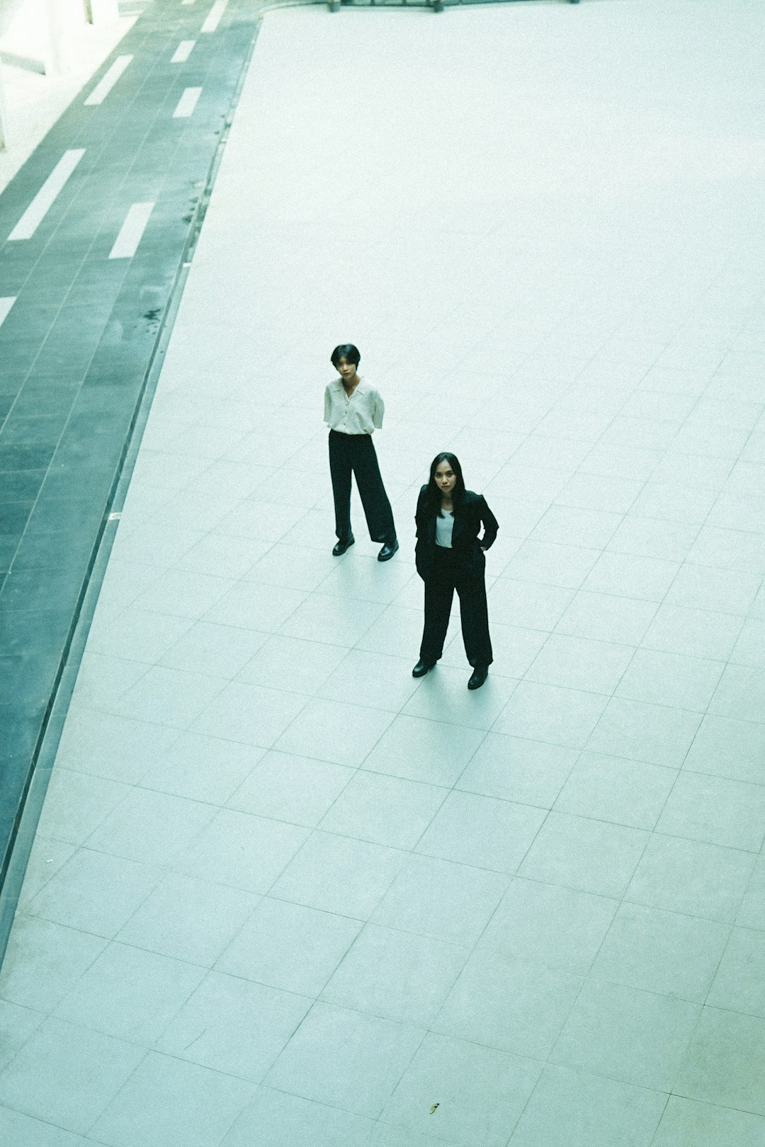 man in black suit jacket standing beside woman in white long sleeve shirt