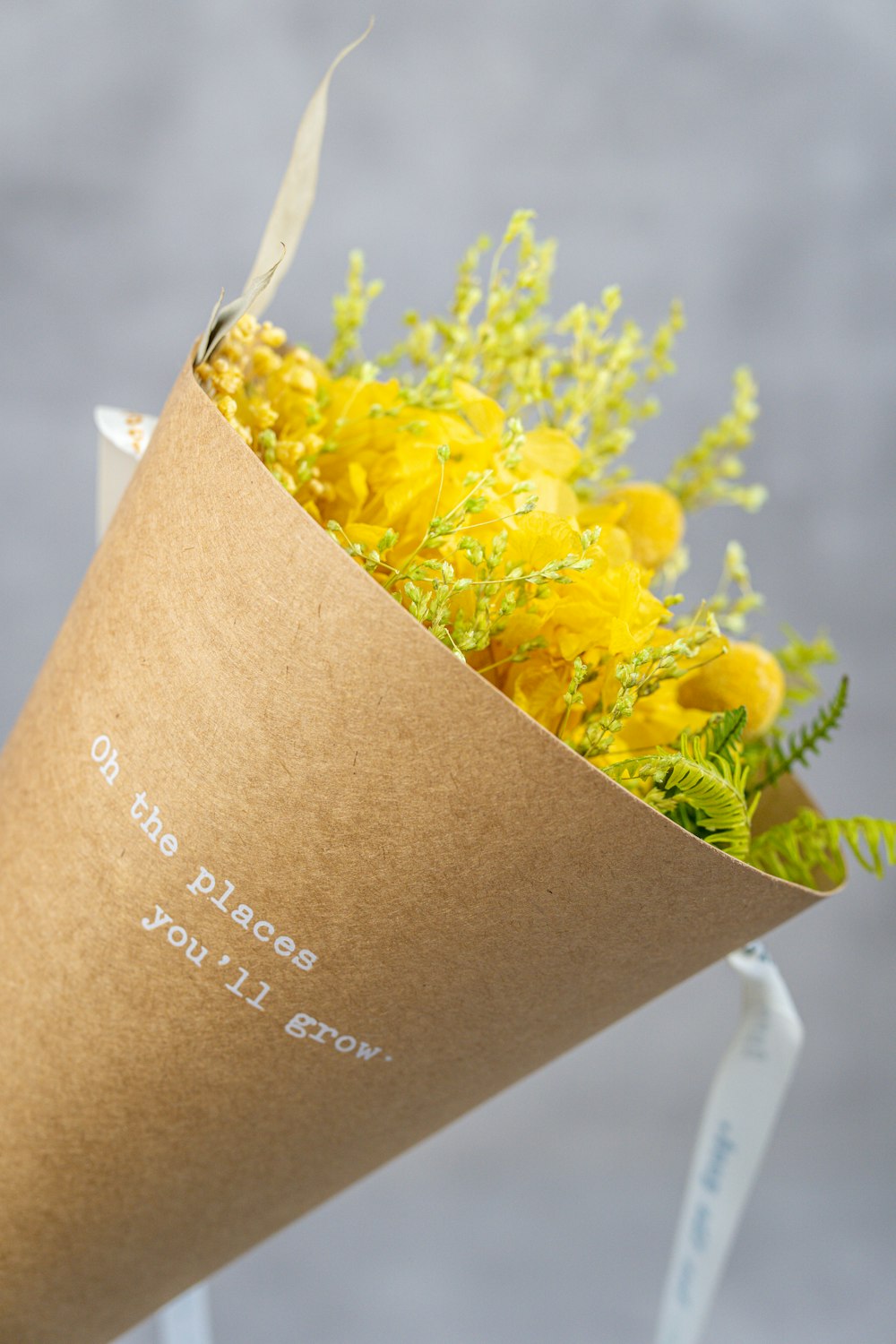 yellow flower on brown paper bag