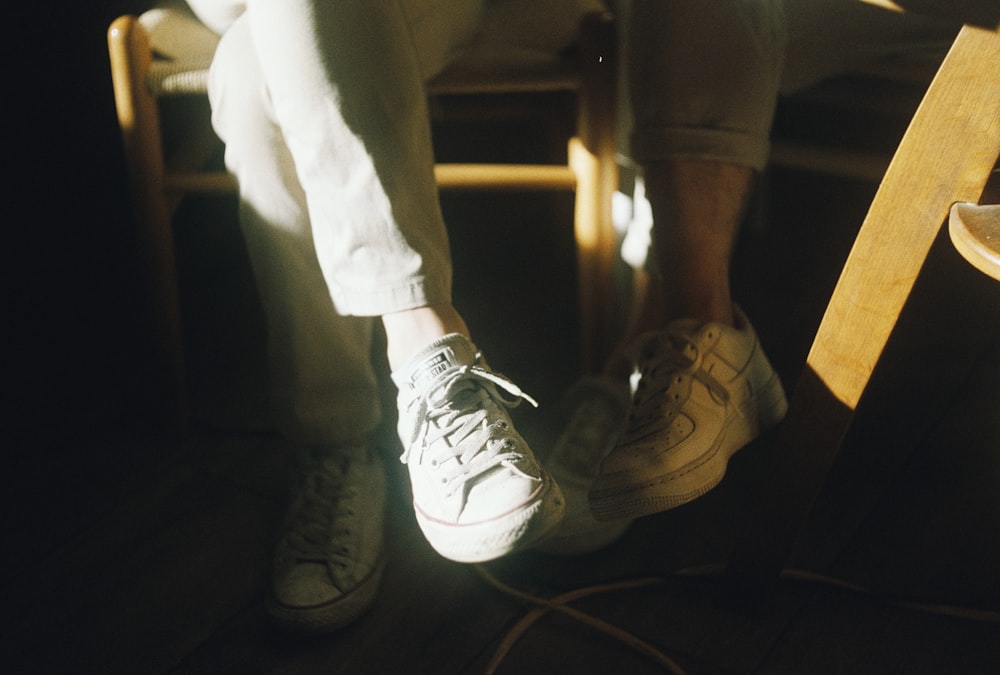 person wearing white nike sneakers