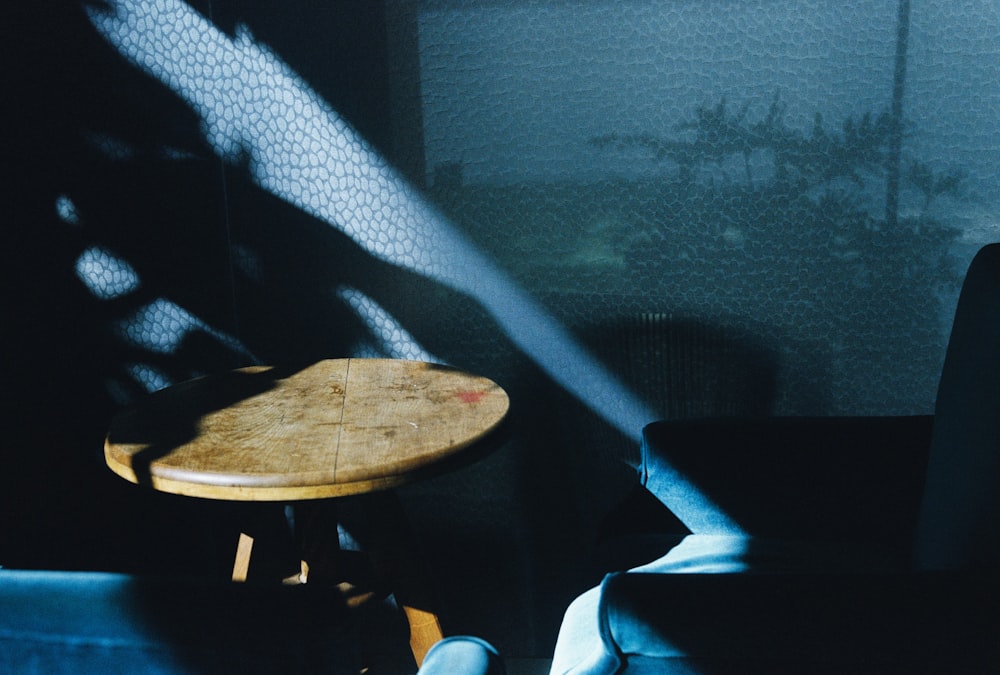 brown wooden round table near black chair