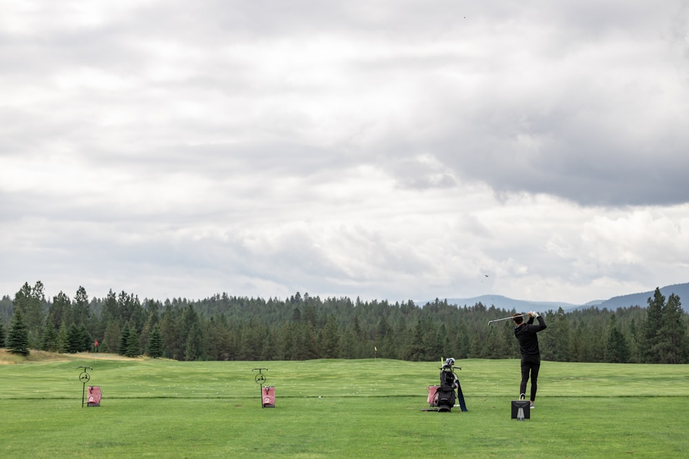 2 person standing on green grass field during daytime