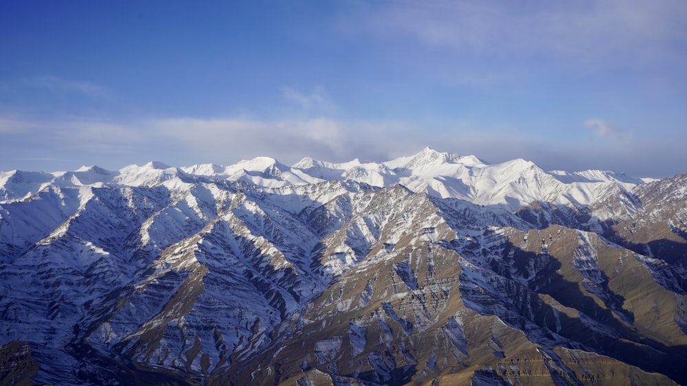 snow covered mountains under blue sky during daytime