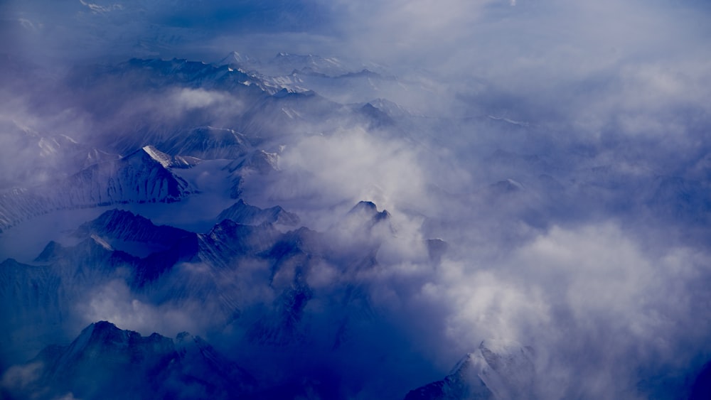 white clouds over blue mountain