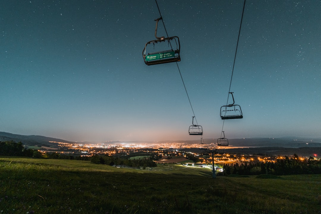 cable car over green grass field during night time