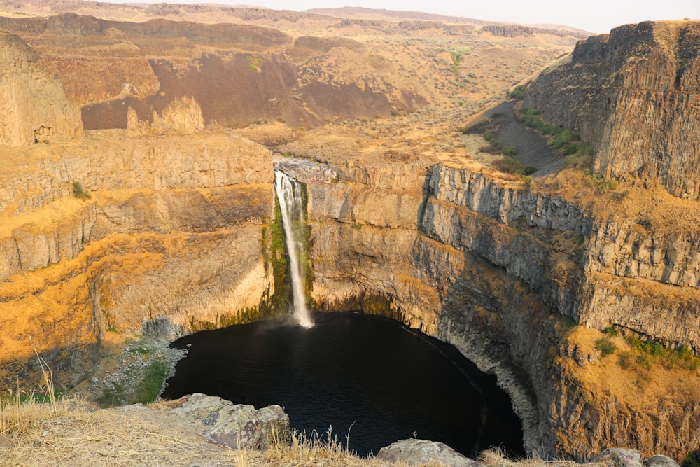 a waterfall in the middle of a canyon