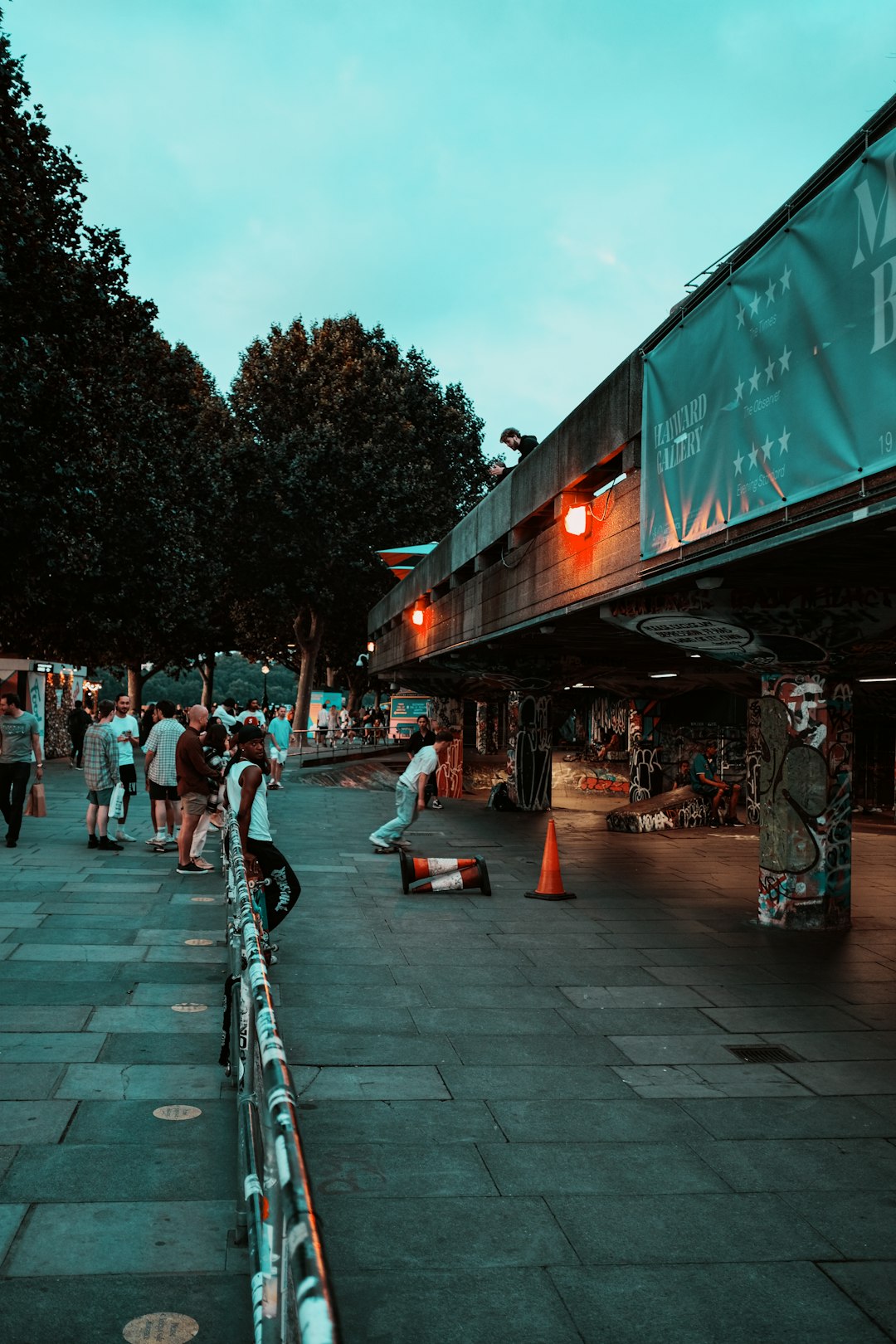 people walking on sidewalk during night time