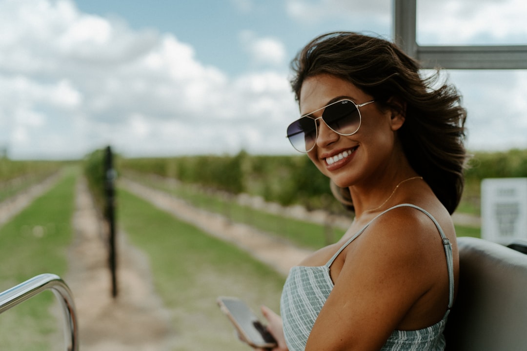 woman in white tank top wearing sunglasses