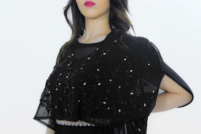 A deep navy abaya featuring intricate beadwork and a modern cut.