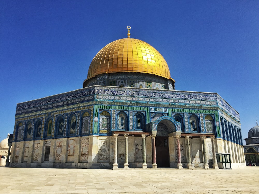 green and beige dome building under blue sky during daytime