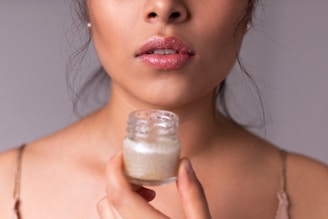 woman holding white plastic bottle
