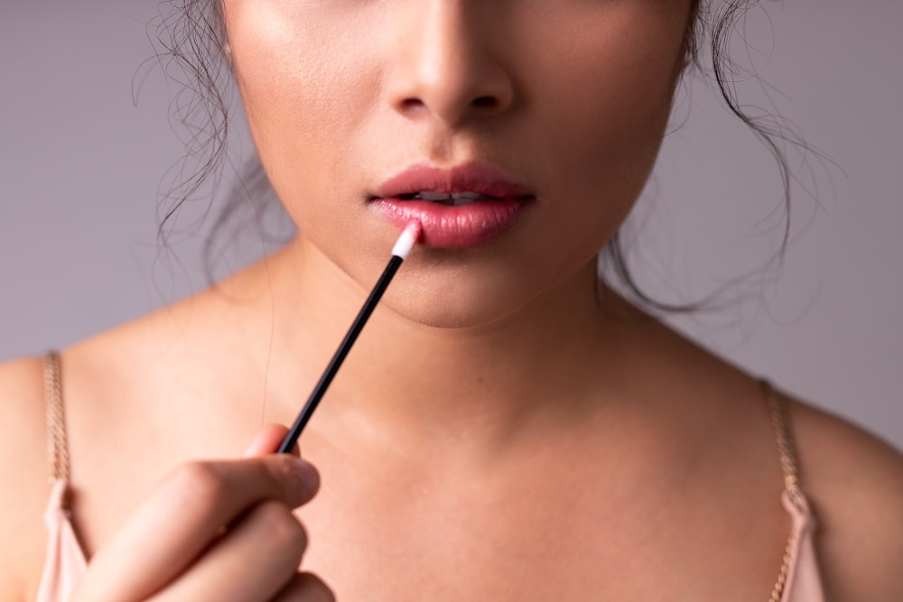 woman with red lipstick and black mascara