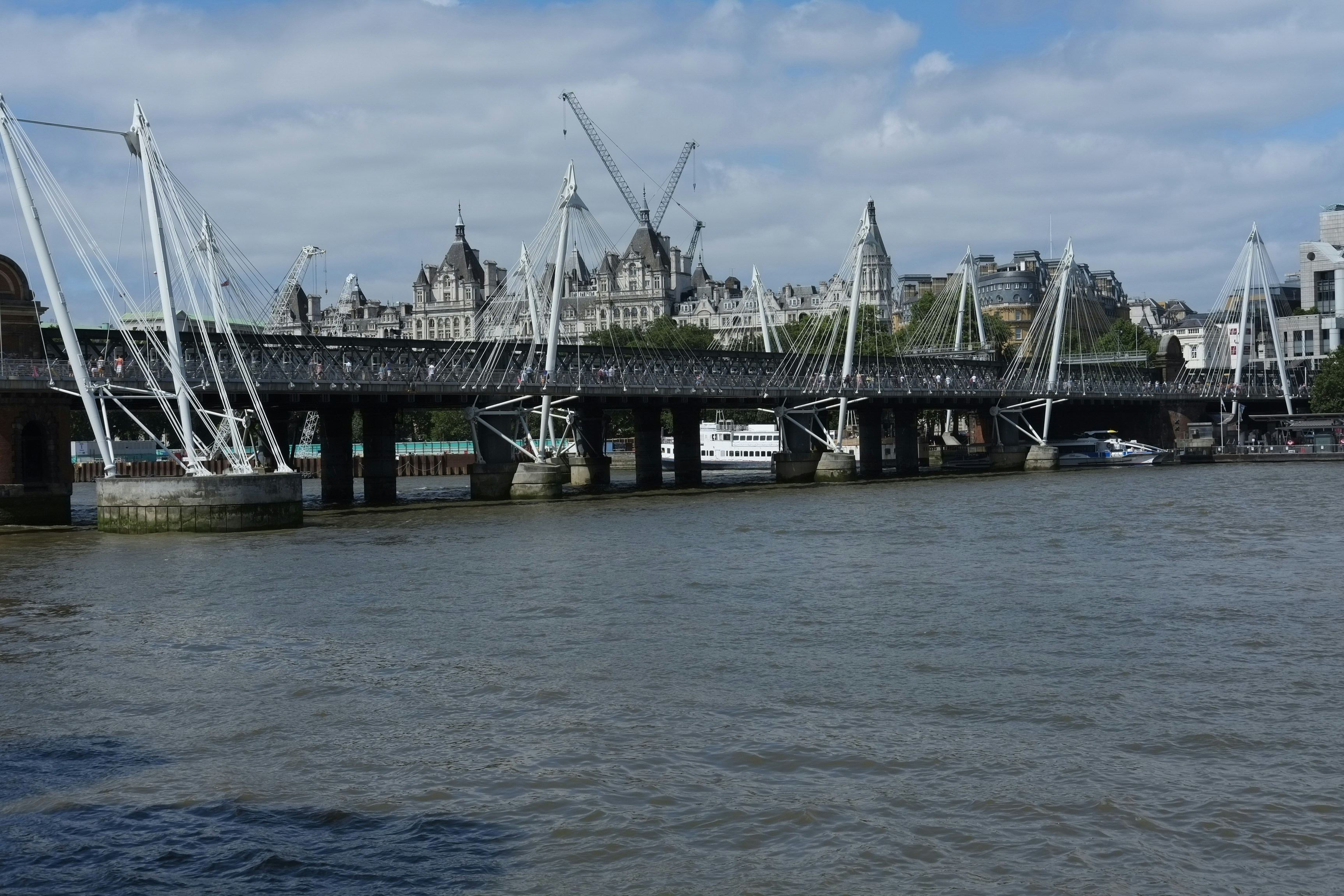 black and white bridge on body of water during daytime