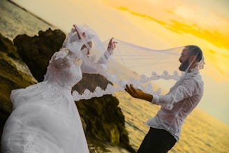 woman in white wedding dress holding bouquet of white flowers