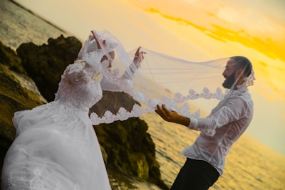 woman in white wedding dress holding bouquet of white flowers
