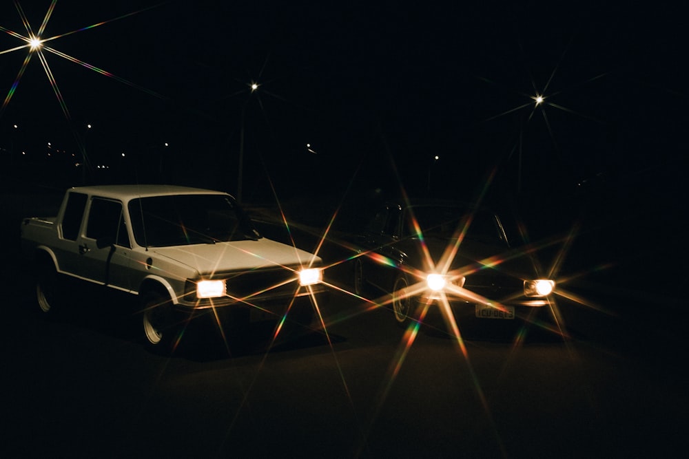 white car on road during night time