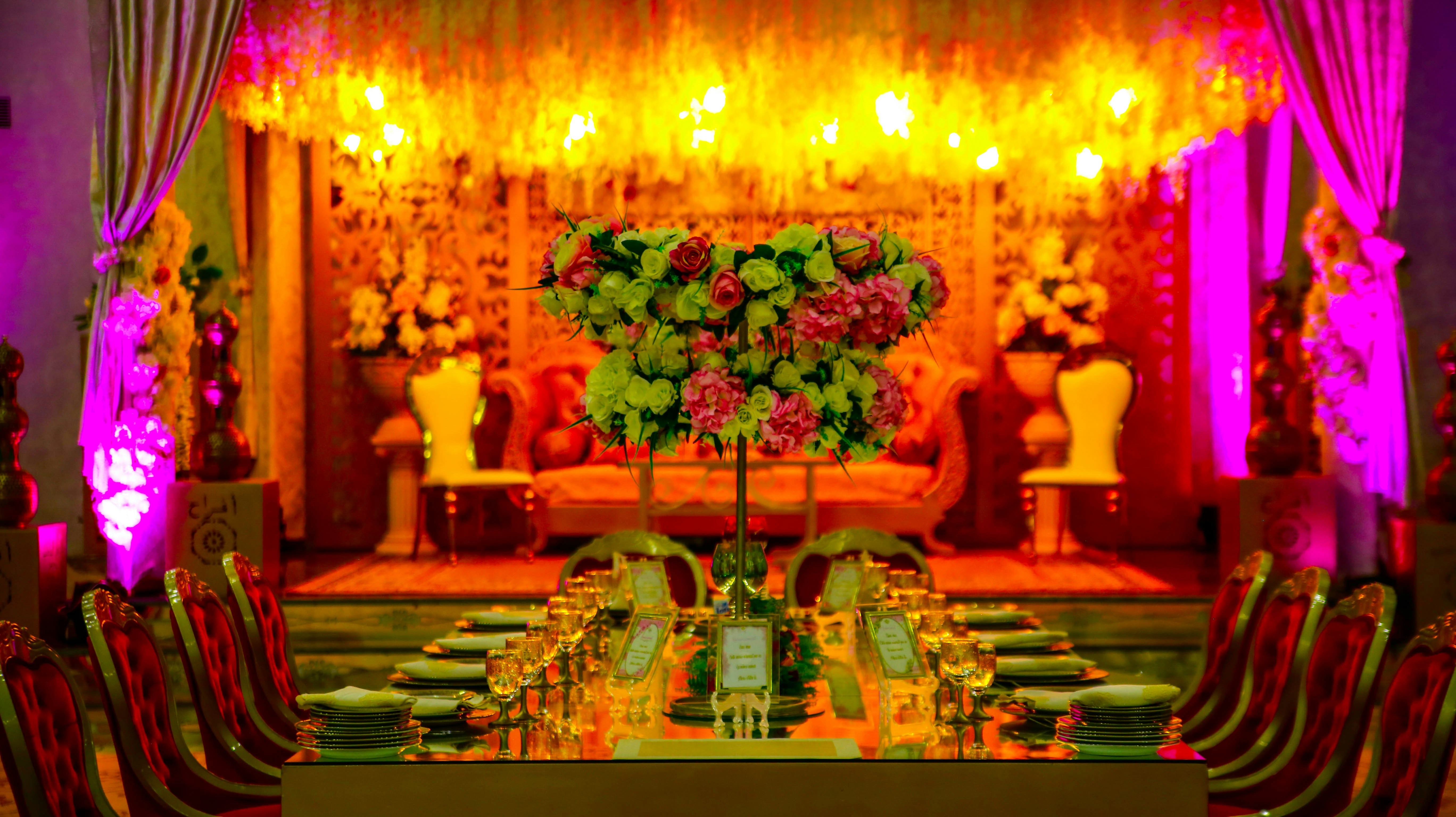 red and yellow flowers on brown wooden table