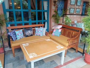 Outdoor bolster pillows arranged on a patio.
