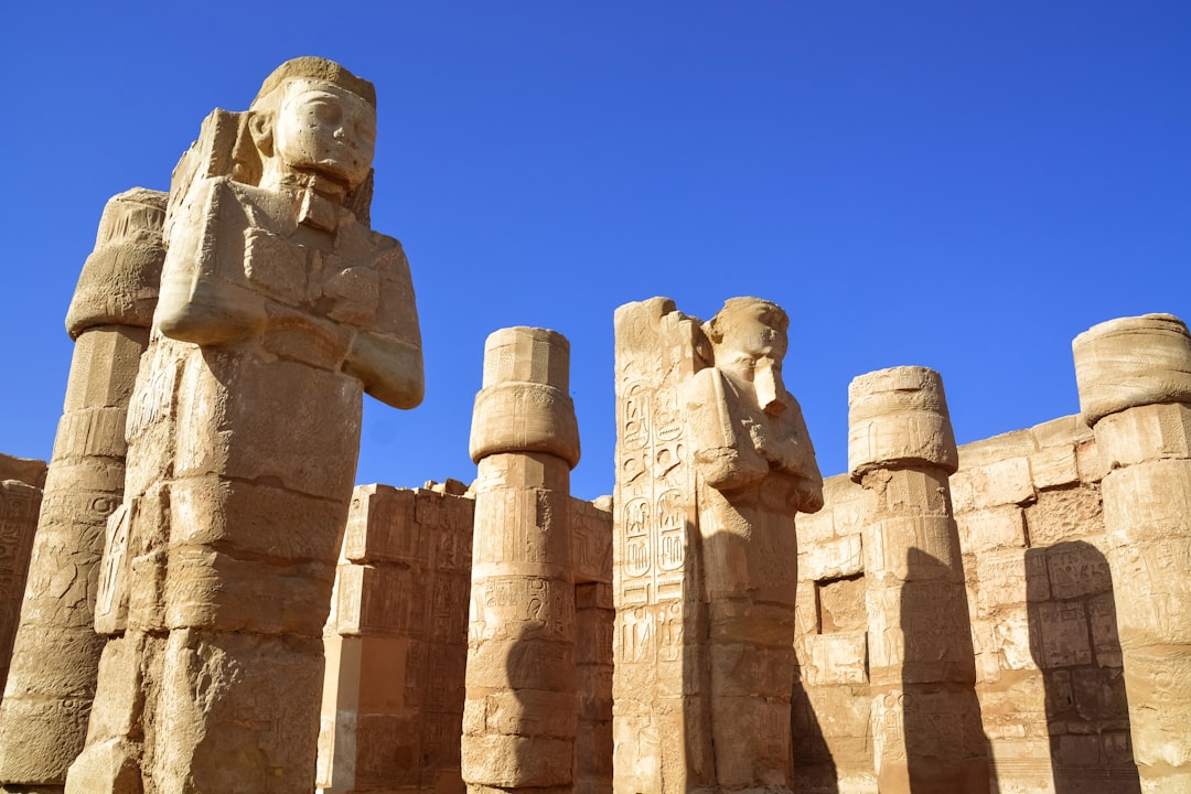 brown concrete statues under blue sky during daytime