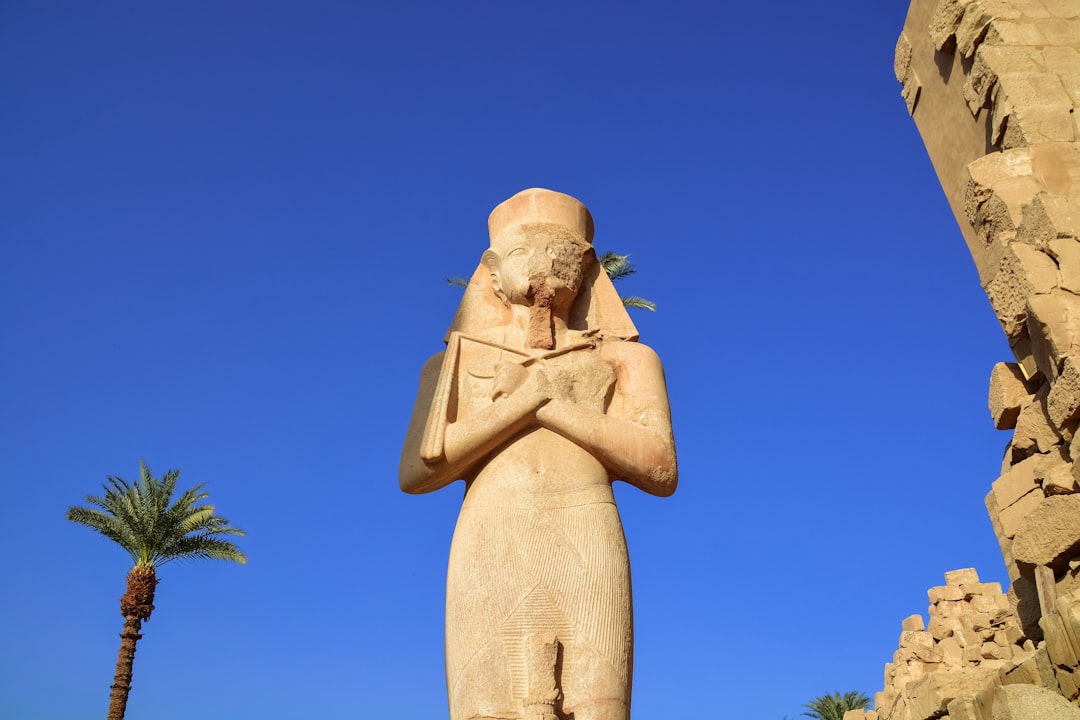 brown concrete statue under blue sky during daytime